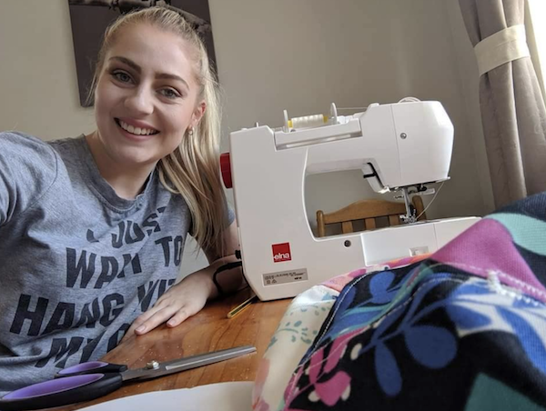 Emily sewing her products from home