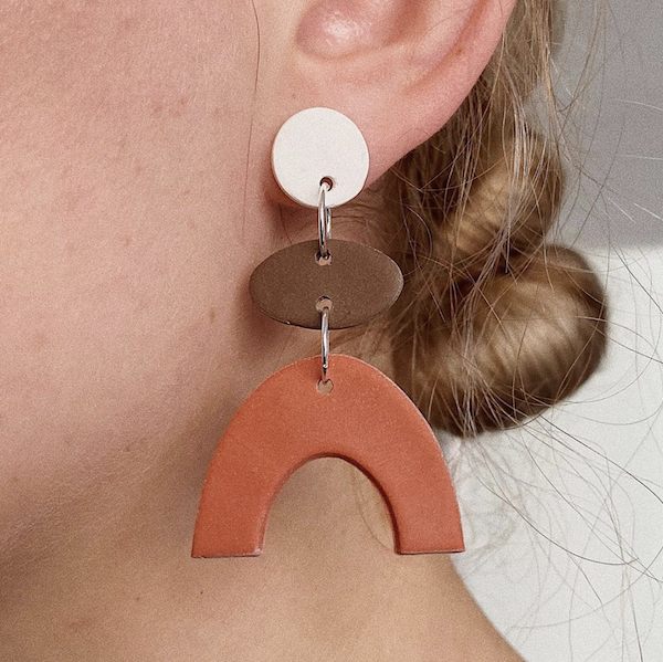 A model wearing handmade earrings from Murph & Sax